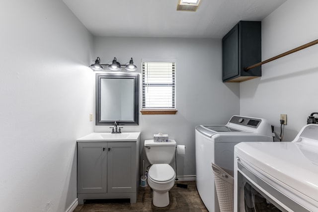 clothes washing area with washing machine and dryer and sink