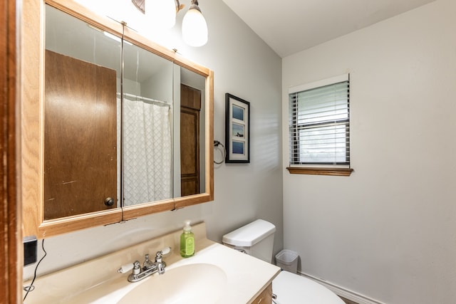 bathroom featuring toilet and vanity