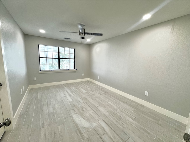 empty room with light hardwood / wood-style floors and ceiling fan