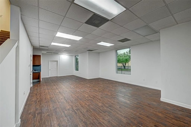 9788 Clarewood Dr Unit 201, Houston, TX 77036 - unfurnished room featuring dark wood-style flooring, a drop ceiling, baseboards, and stairs