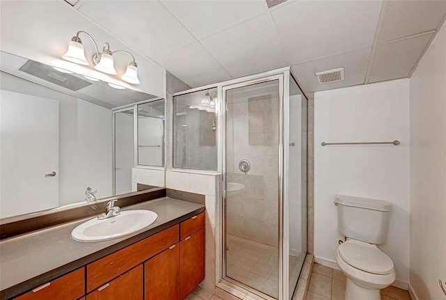 9788 Clarewood Dr Unit 201, Houston, TX 77036 - bathroom featuring toilet, vanity, a stall shower, and tile patterned floors