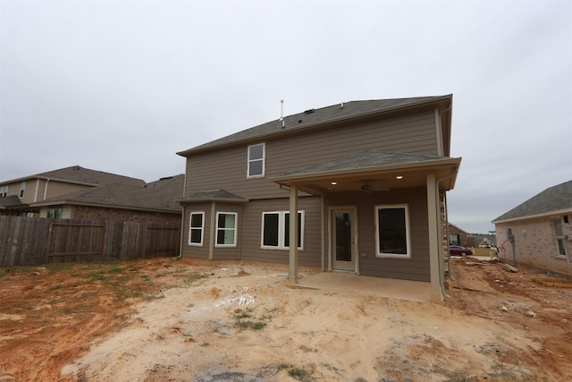 back of property with a patio area and fence