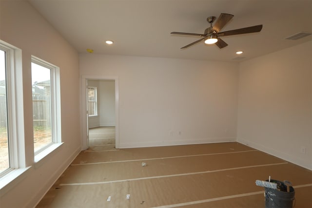 unfurnished room with a ceiling fan, recessed lighting, visible vents, and baseboards