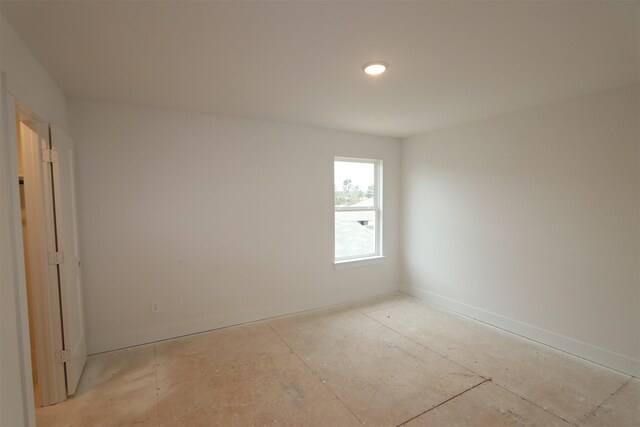 spare room with baseboards