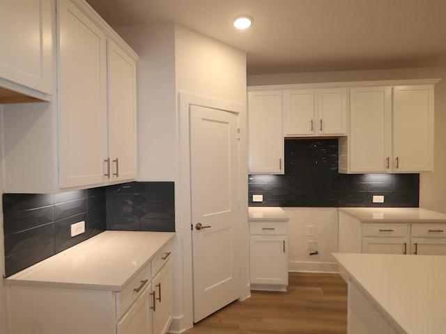 234 Augustine Way, Magnolia, TX 77354 - kitchen with wood finished floors, white cabinets, tasteful backsplash, recessed lighting, and light countertops