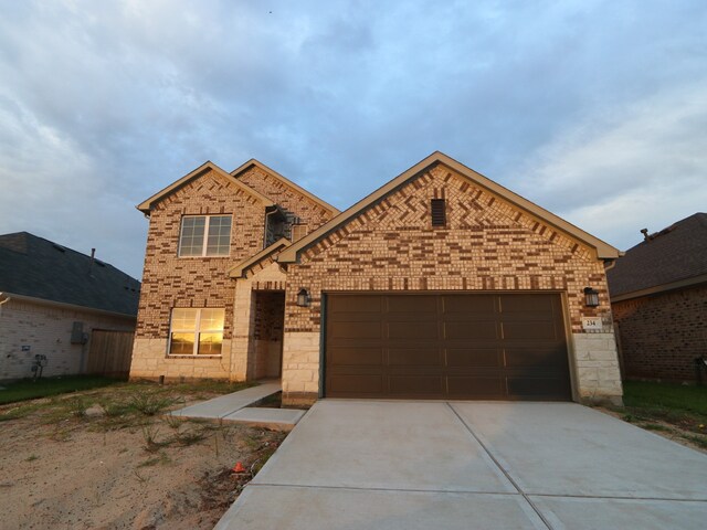 234 Augustine Way, Magnolia, TX 77354 - traditional-style house featuring concrete driveway, an attached garage, and brick siding