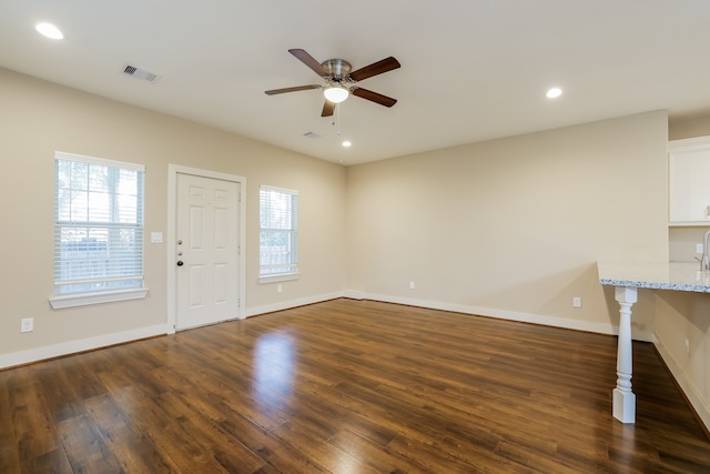 interior space featuring ceiling fan and dark hardwood / wood-style floors