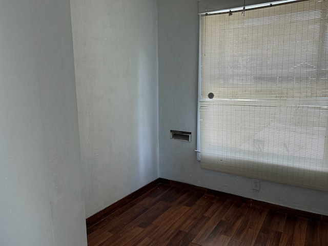 empty room with dark wood-type flooring