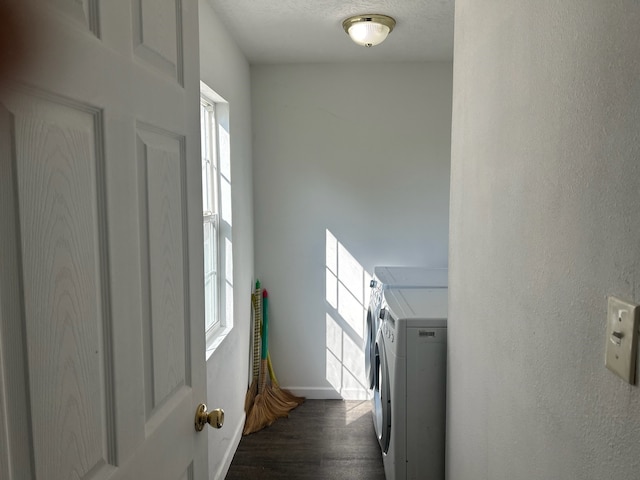 washroom with dark hardwood / wood-style flooring, a wealth of natural light, washing machine and clothes dryer, and a textured ceiling