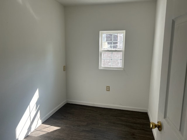 spare room with dark wood-type flooring