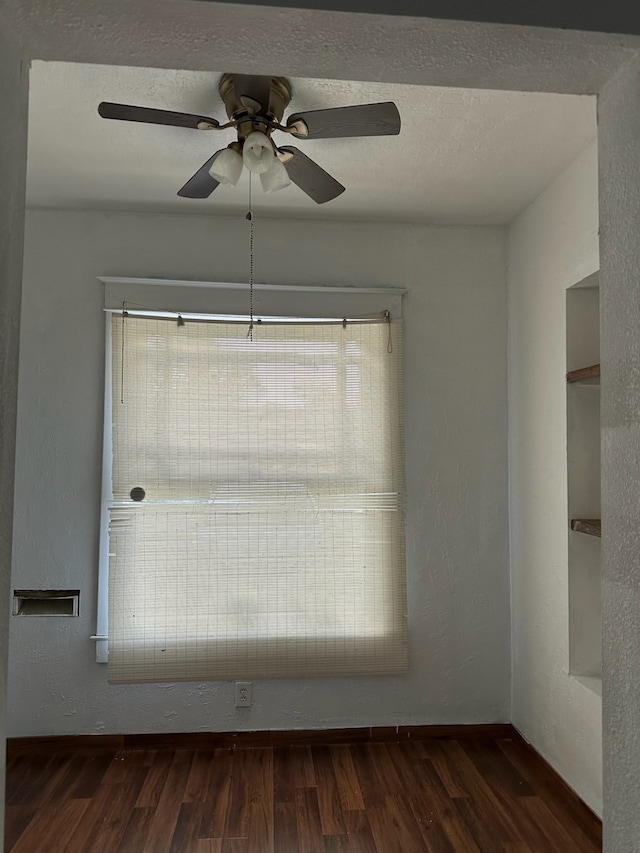 unfurnished room featuring ceiling fan, dark hardwood / wood-style flooring, and a textured ceiling