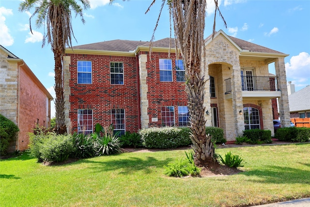 view of front of house with a balcony and a front yard