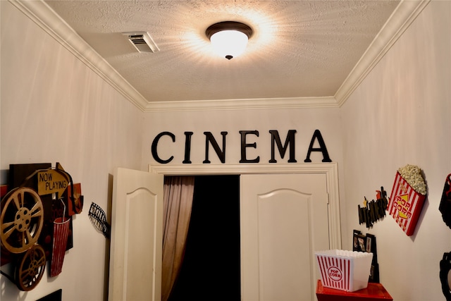 details with ornamental molding and a textured ceiling