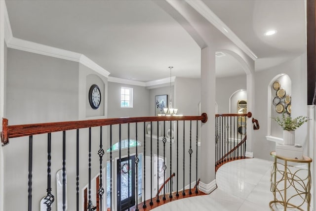 hall featuring crown molding and a chandelier