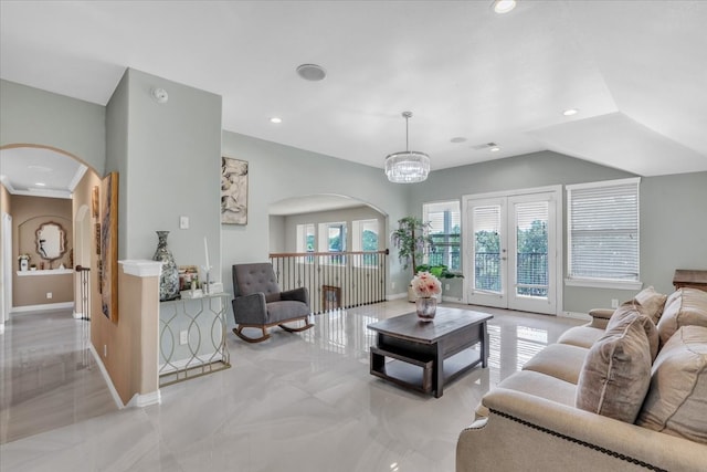 living room with an inviting chandelier and french doors