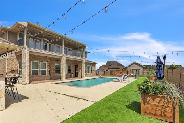 view of swimming pool with a yard and a patio area