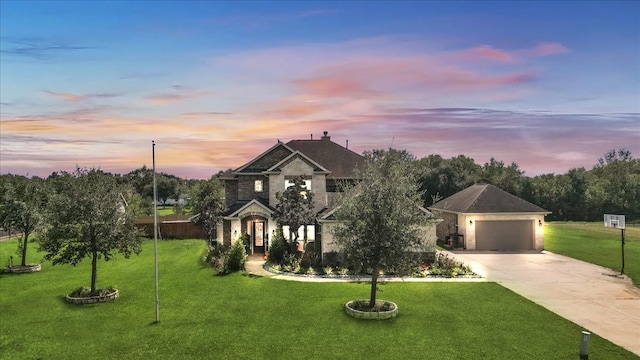 view of front of property featuring a garage and a yard