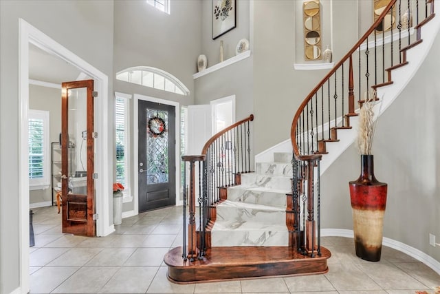 tiled entryway featuring a high ceiling