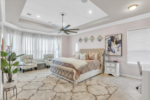 tiled bedroom featuring a raised ceiling, ornamental molding, and ceiling fan