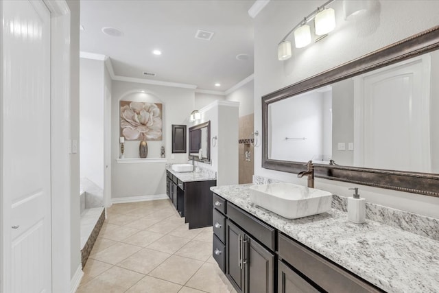 bathroom featuring vanity, crown molding, tile patterned floors, and a bathing tub