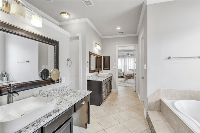 bathroom featuring vanity, ceiling fan, tiled tub, crown molding, and tile patterned floors