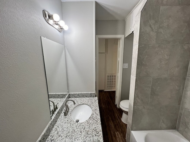 bathroom featuring toilet, hardwood / wood-style floors, and sink