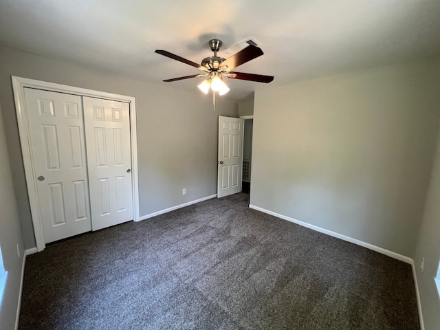 unfurnished bedroom featuring dark carpet, ceiling fan, and a closet