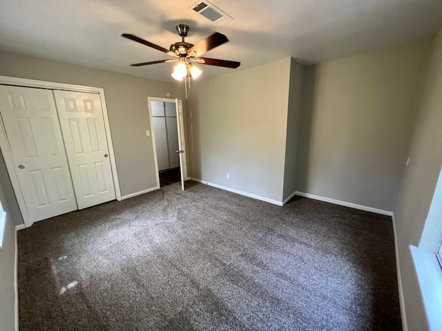 unfurnished bedroom featuring ceiling fan and dark colored carpet