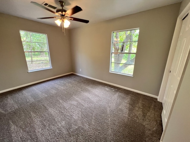 carpeted spare room with ceiling fan