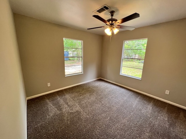 unfurnished room with a wealth of natural light, carpet, and ceiling fan