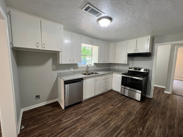 kitchen featuring appliances with stainless steel finishes, dark hardwood / wood-style flooring, white cabinetry, and sink