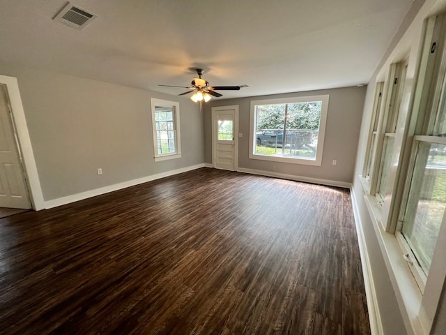 empty room featuring dark wood-type flooring and ceiling fan