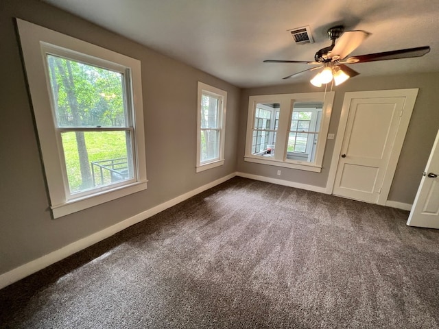 interior space featuring ceiling fan and carpet