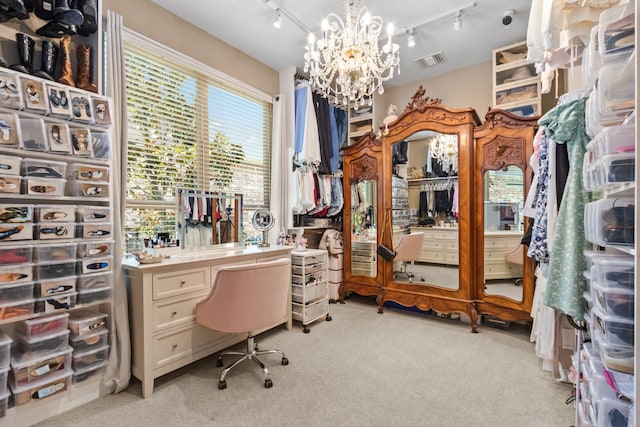 home office featuring rail lighting, an inviting chandelier, and light colored carpet