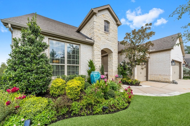 view of front facade with a front lawn and a garage