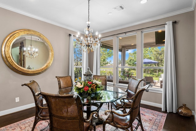 dining room featuring a notable chandelier, dark wood-type flooring, and crown molding