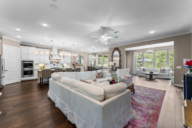 living room featuring wood-type flooring, ceiling fan with notable chandelier, and ornamental molding