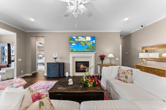 living room featuring ceiling fan, ornamental molding, and dark hardwood / wood-style flooring