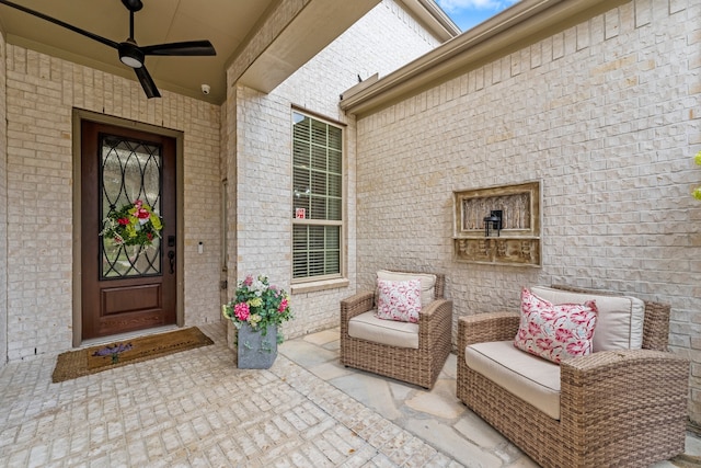 entrance to property featuring ceiling fan and a patio area