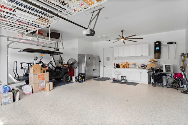 garage with a garage door opener, ceiling fan, and stainless steel refrigerator