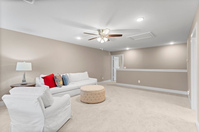 carpeted living room with ceiling fan