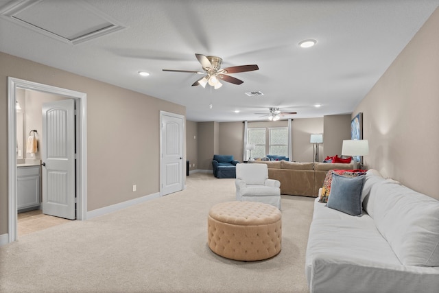 carpeted living room with ceiling fan