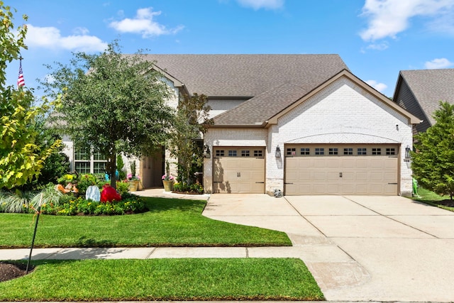 view of front of property with a front lawn and a garage