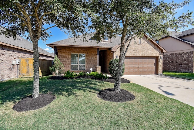 traditional-style home featuring a front lawn, fence, brick siding, concrete driveway, and an attached garage