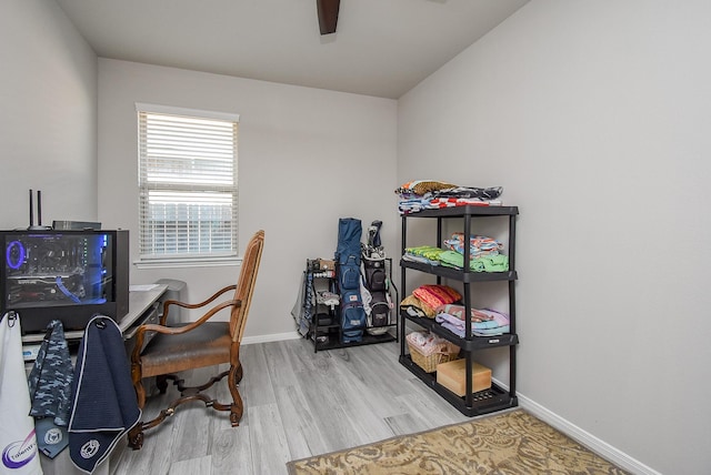 home office featuring baseboards, ceiling fan, and wood finished floors