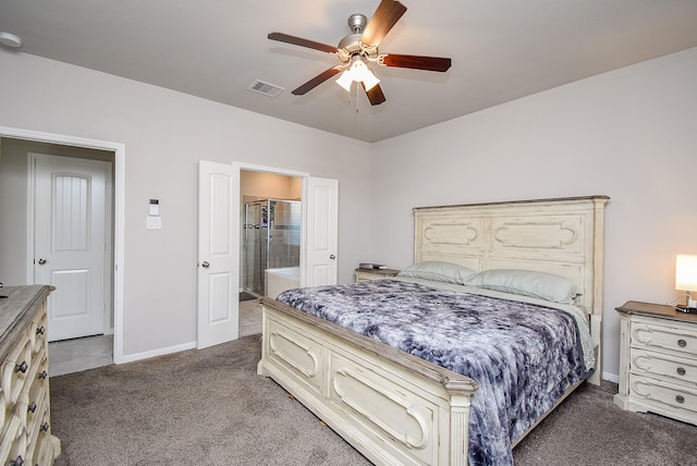 carpeted bedroom featuring a ceiling fan, baseboards, visible vents, and ensuite bath