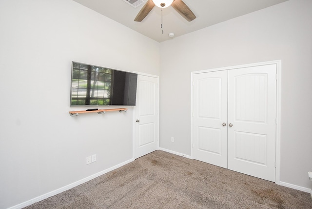 unfurnished bedroom with carpet flooring, ceiling fan, baseboards, visible vents, and a closet