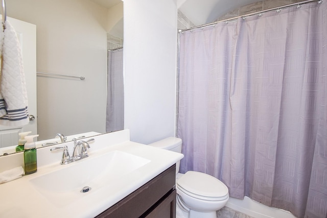 bathroom featuring vanity, toilet, and a shower with shower curtain