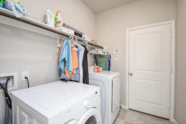 laundry room featuring baseboards, laundry area, and independent washer and dryer