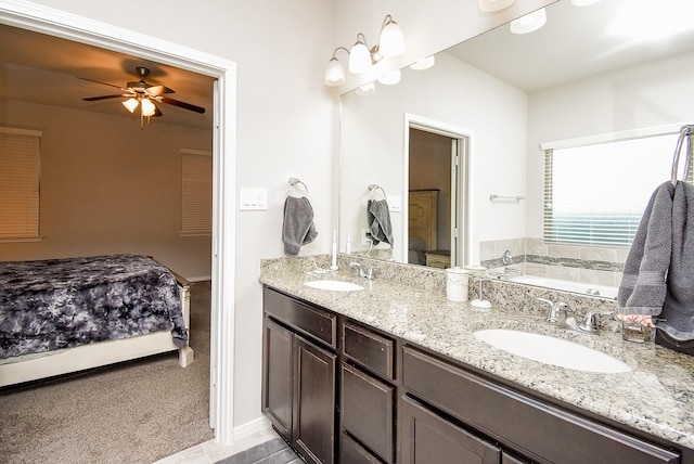 full bathroom with double vanity, a sink, a ceiling fan, and a bath